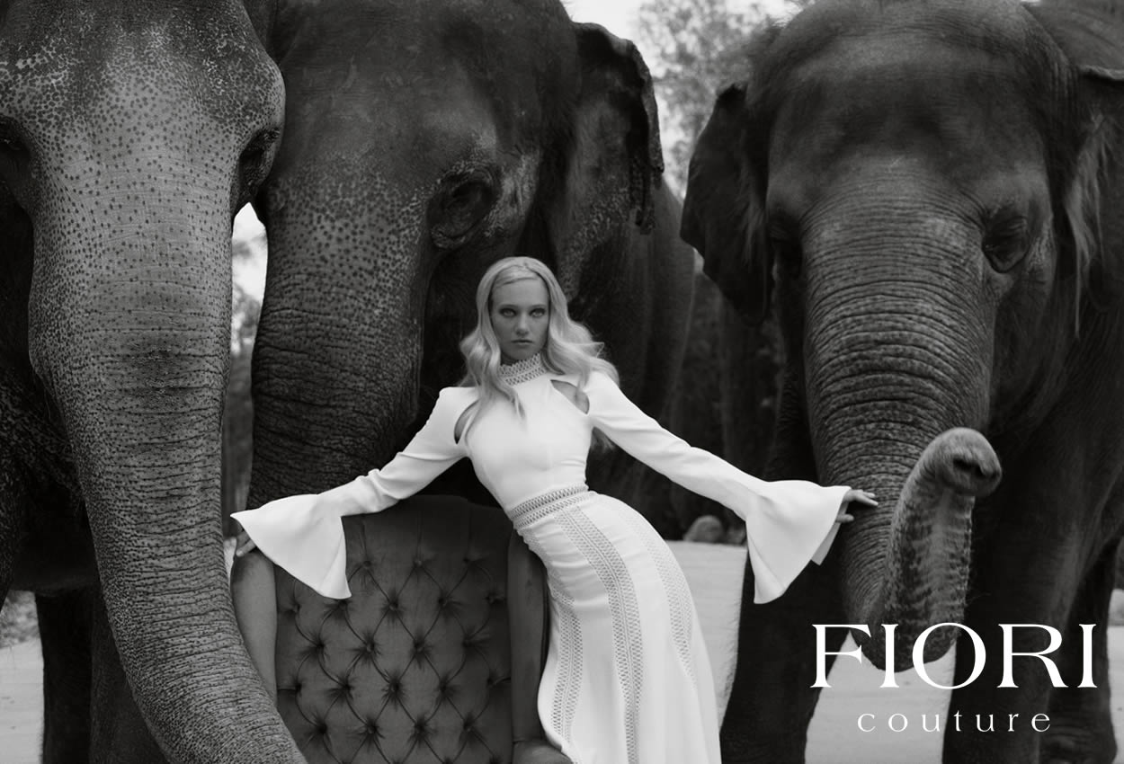 Woman wearing Vintage Chanel poses with elephants